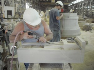 Two craftsman hand carve limestone 